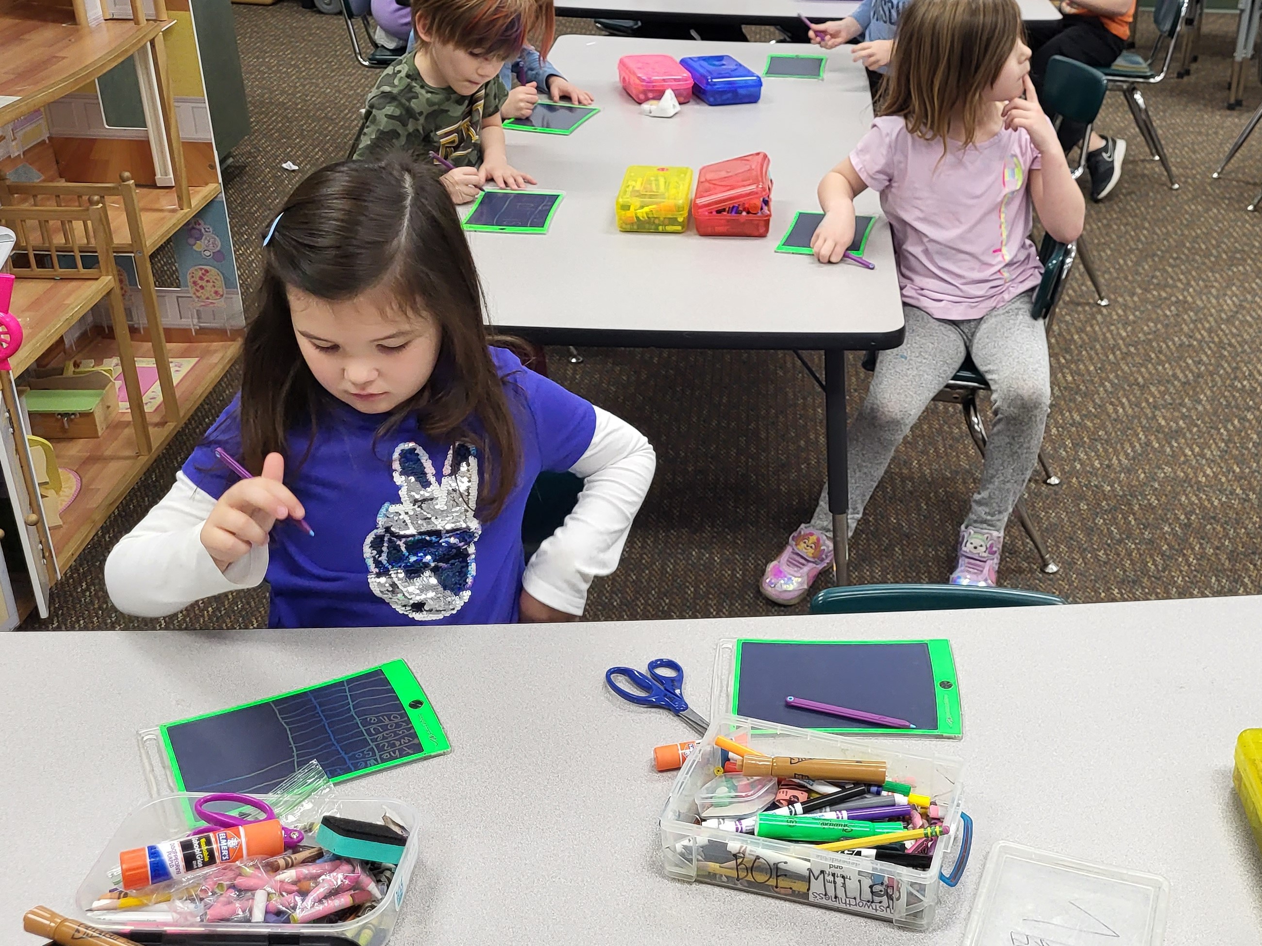 Kindergarten students using boogie Boards in class to practice handwriting. 