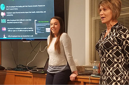 Two financial advisors speaking to group