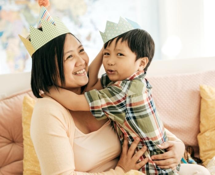 Mom and child wearing paper crowns
