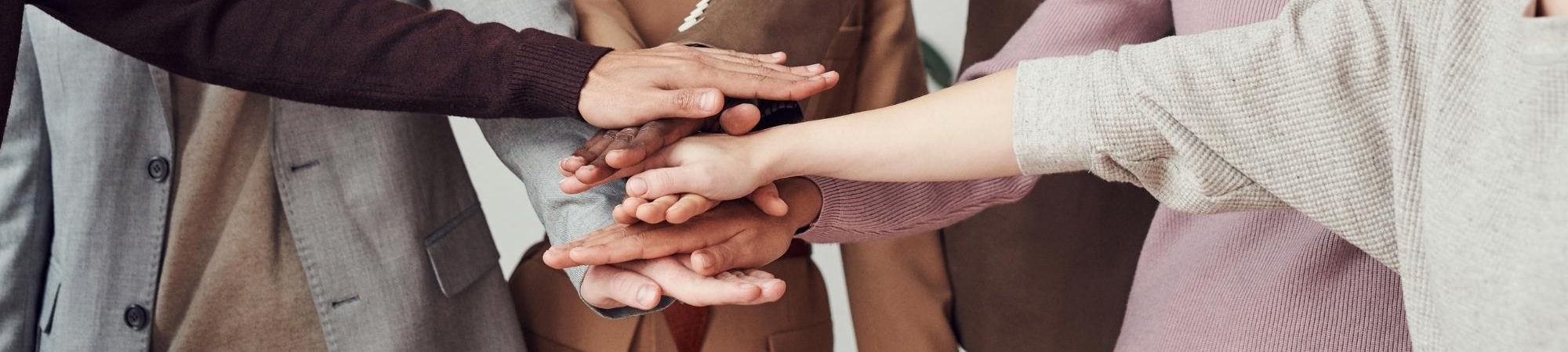 People with hands stacked