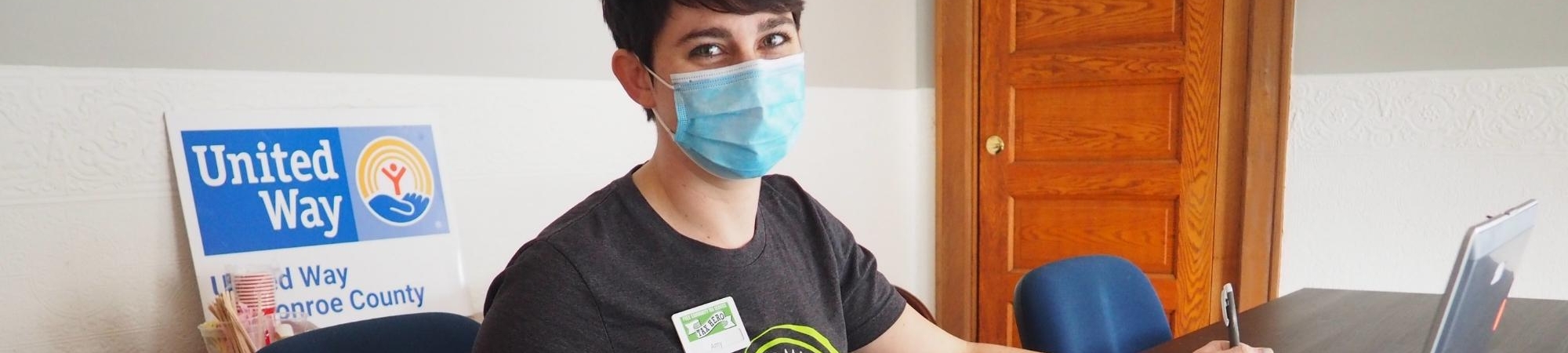 Woman at computer wearing face mask