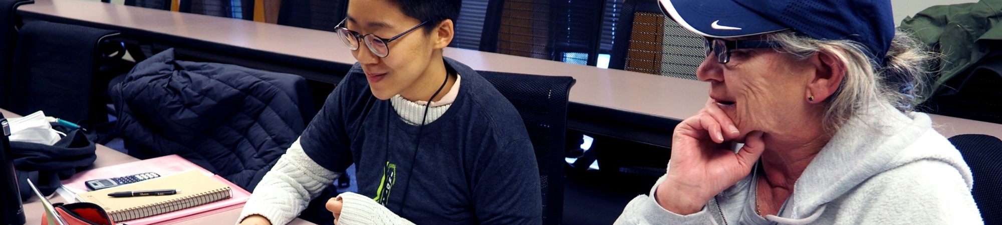 Two people working at laptop computer