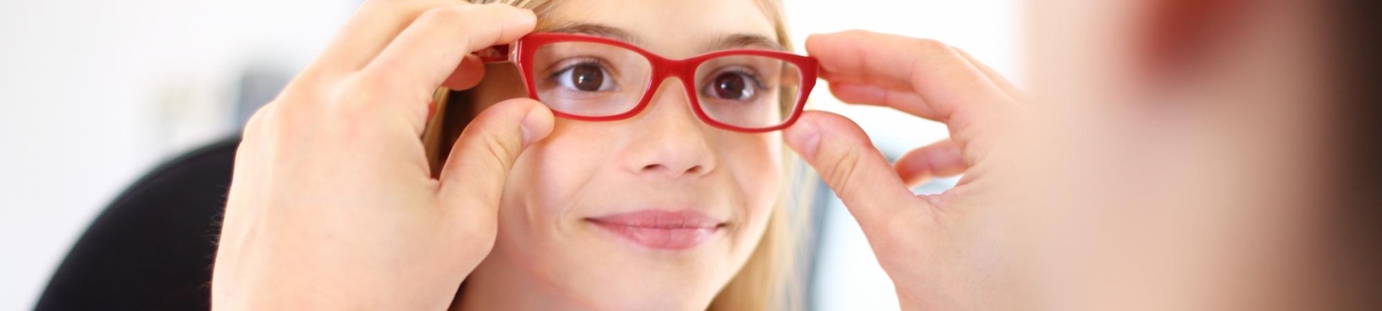 Child being fit for eyeglasses