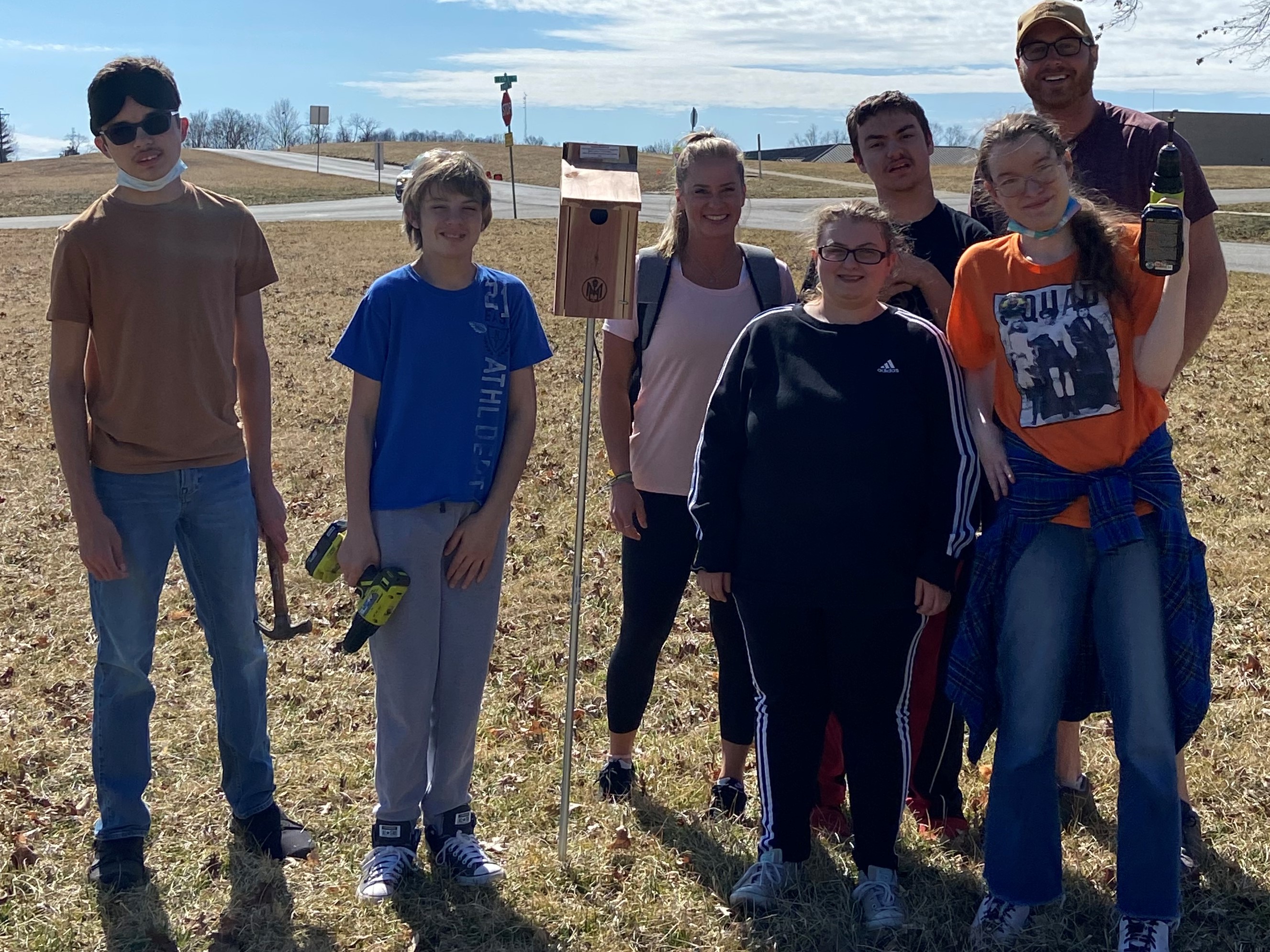 High school students with the bird house they installed along Norman’s Bluebird Trail