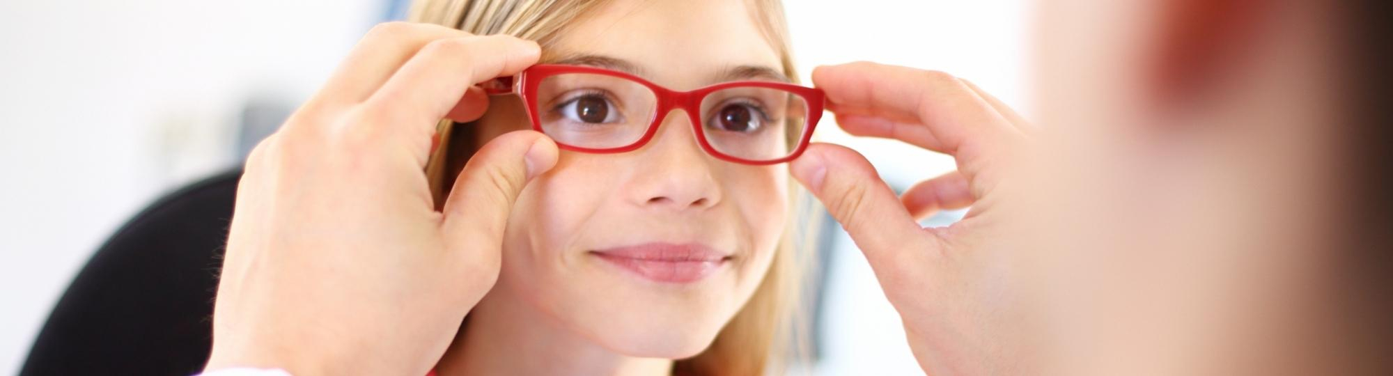 Child being fit for eyeglasses